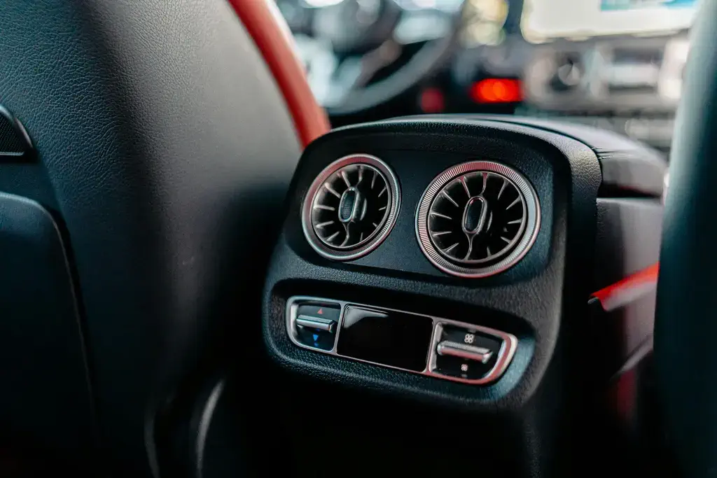ASE certified mechanic inspecting climate control components